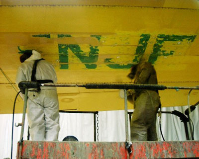 Last traces of former registration C-FNJF are removed for repaint, May 2005