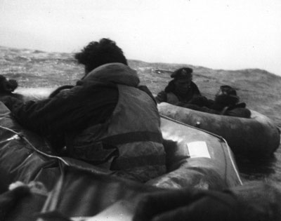 The crew of 44-33915 sit it out in their dinghies and await their eventual rescue
