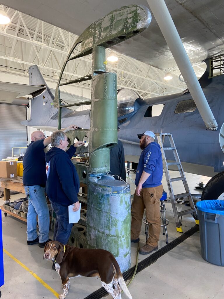 Looking surprisingly large when on the ground, the rudder of the Military Aviation Museum’s N9521C during refurbishment earlier this year at Virginia Beach.  The dog is clearly not impressed with the Cat’via Military Air Museum 